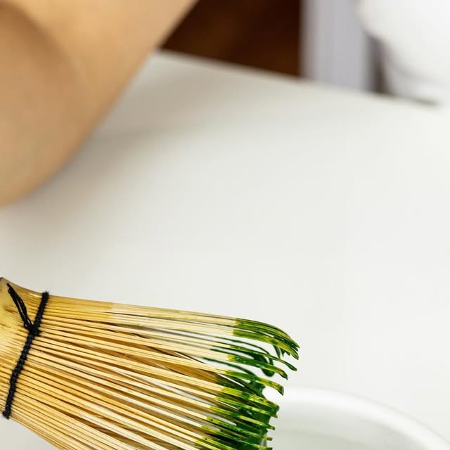 Chasen bamboo whisk preparing ceremonial matcha